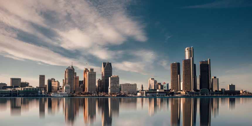 Detroit sykline showing skyscrapers reflecting off Detroit river