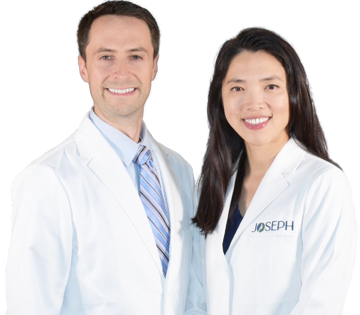 Photo of Dr. Andrew W. Joseph and Dr. Shannon S. Joseph in white coats facing camera.